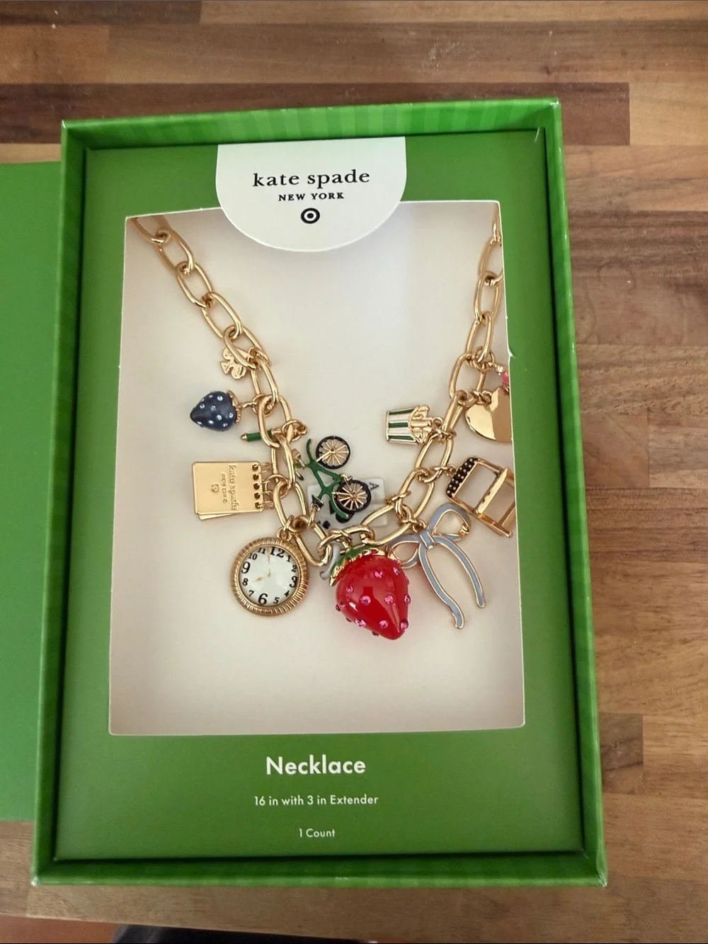 kate spade gold-tone charm necklace with red strawberry and black accents